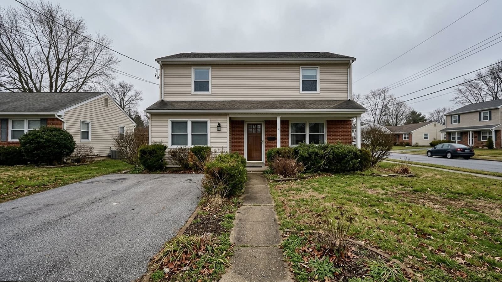 Overcast exterior listing photo with flat lighting and tired landscaping before AI photo editing