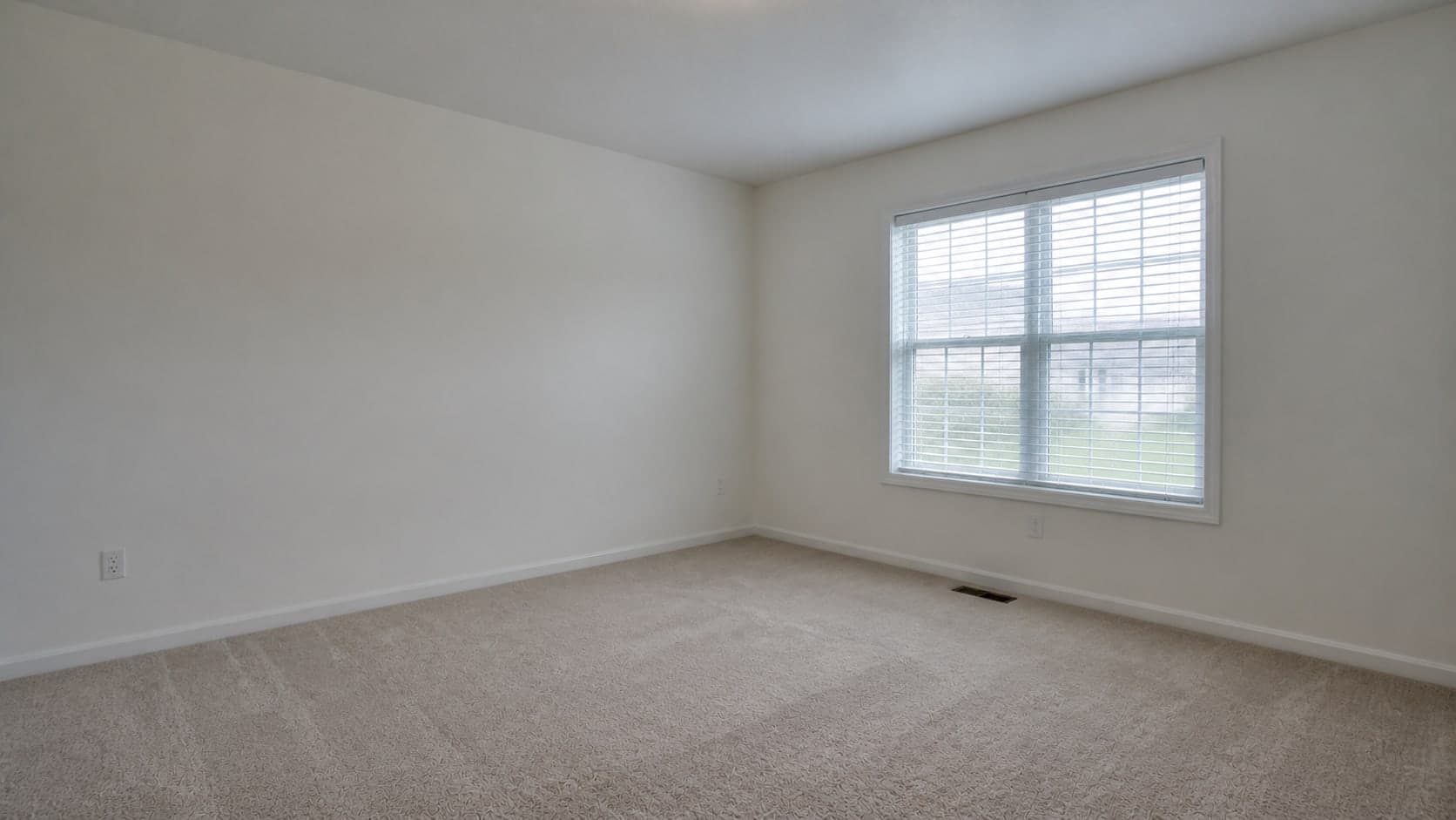 Empty room listing photo with flat lighting and mild perspective issues before AI correction and staging